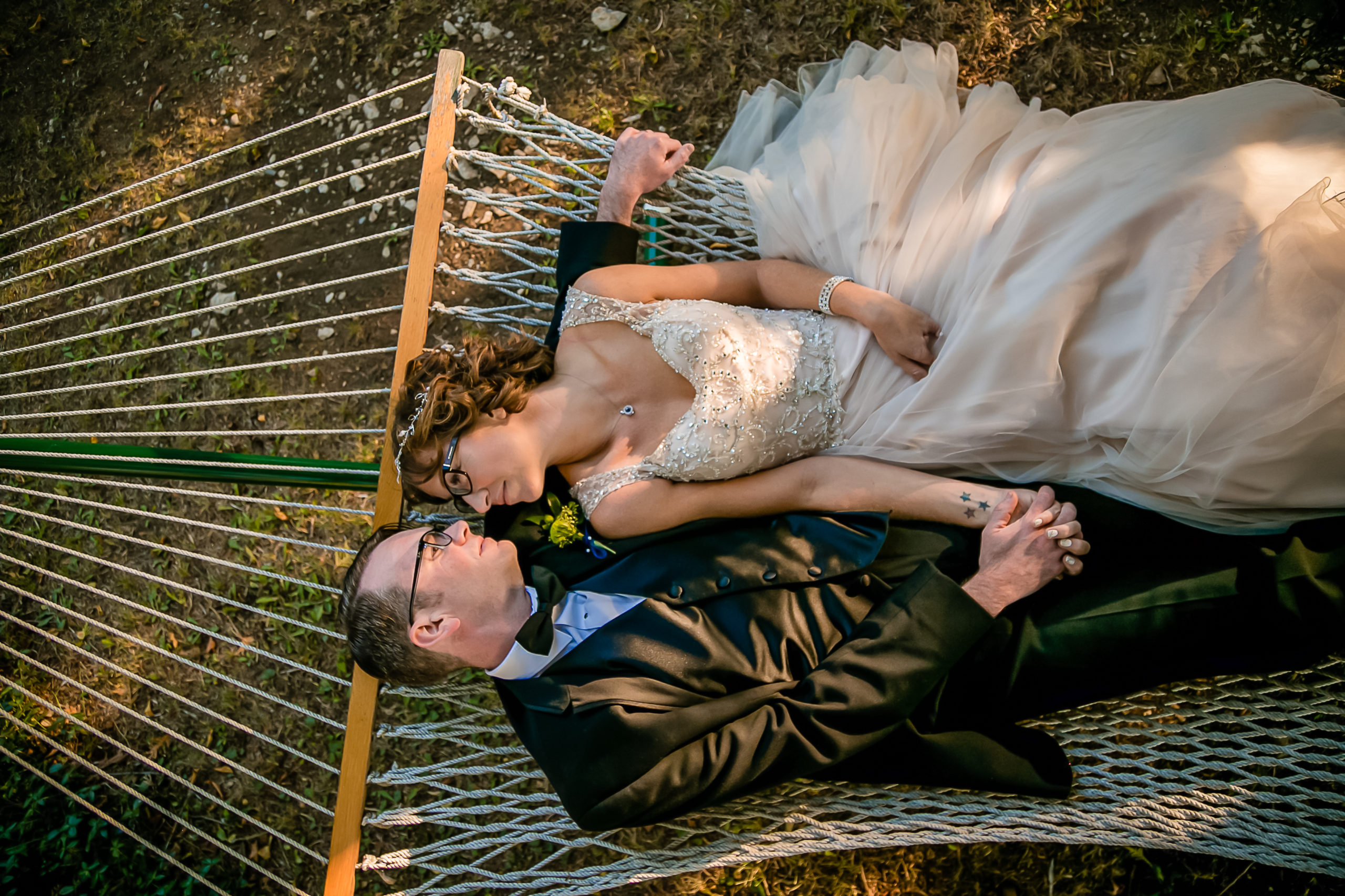 Couple relaxing in a hammock on their wedding day