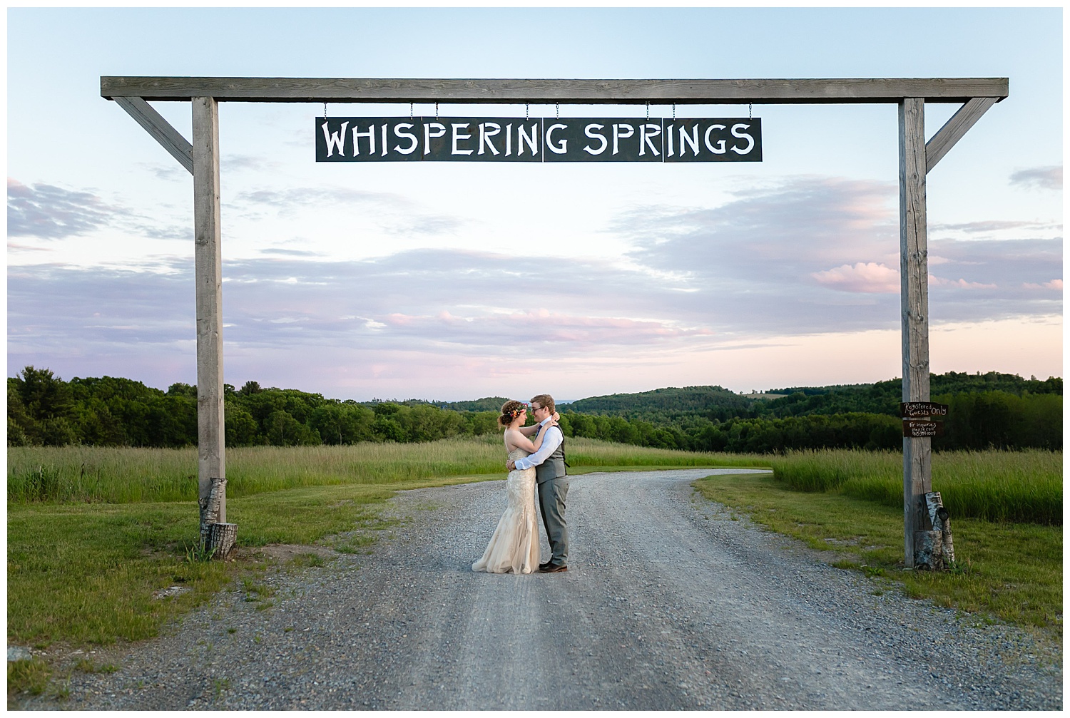 couple under the whispering springs sign